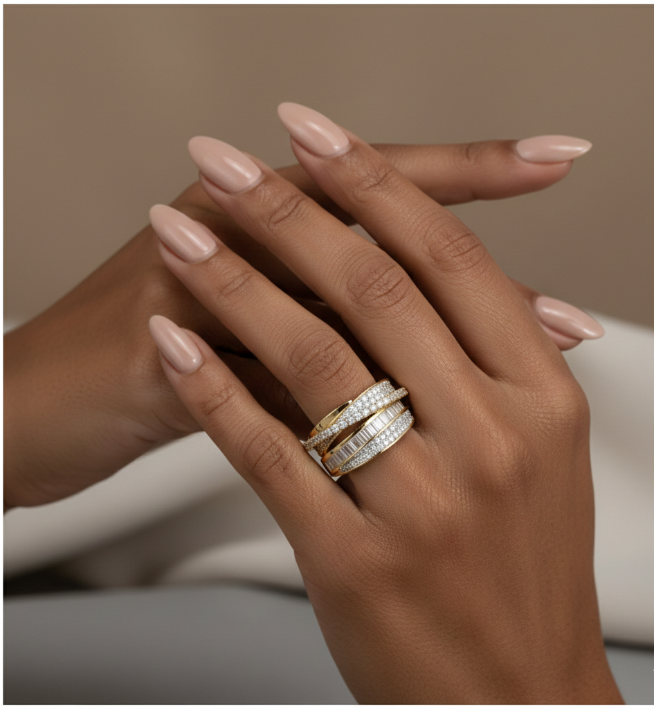 Hand wearing multiple rings with a neutral background