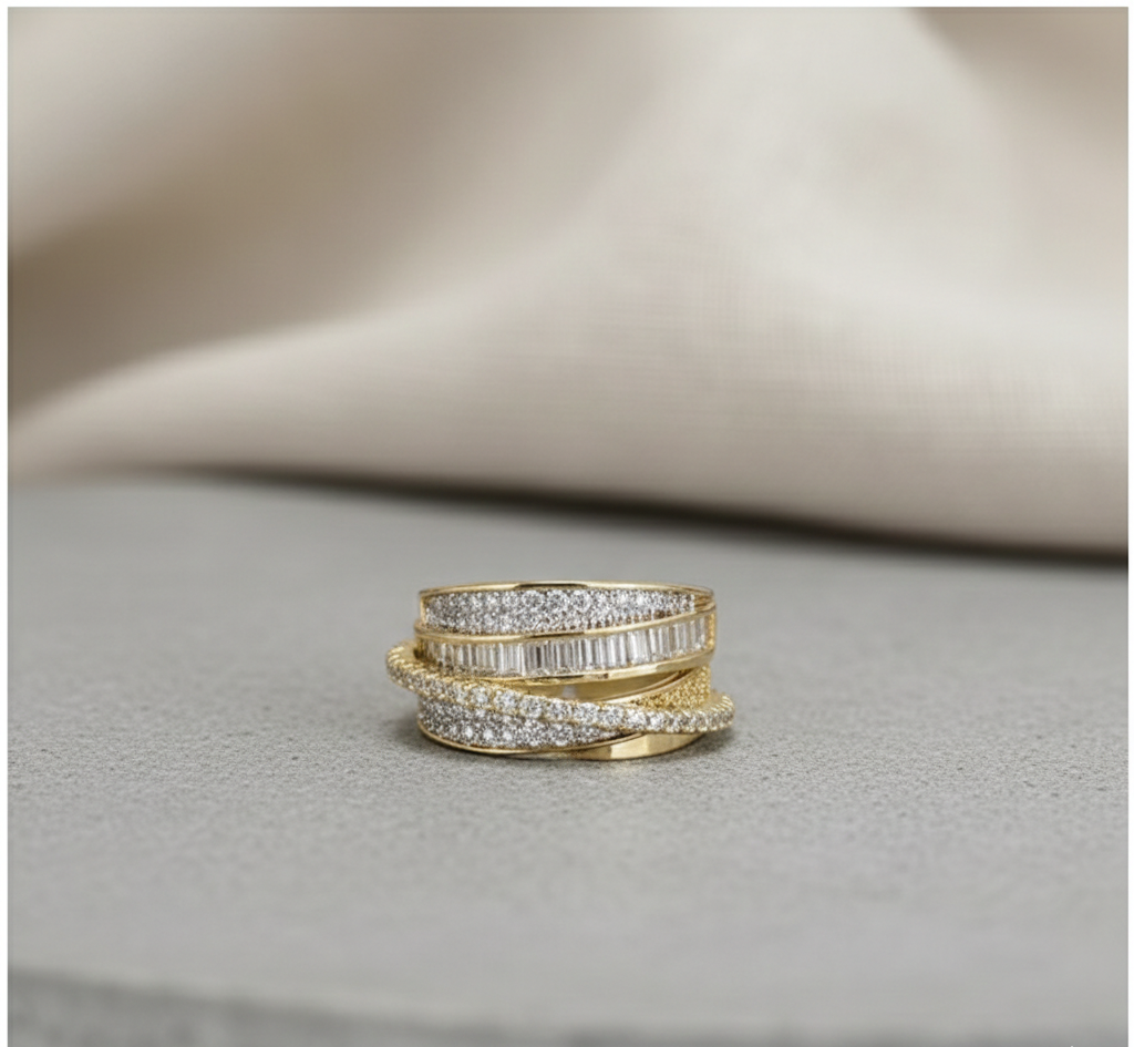 Stack of gold and diamond rings on a textured surface