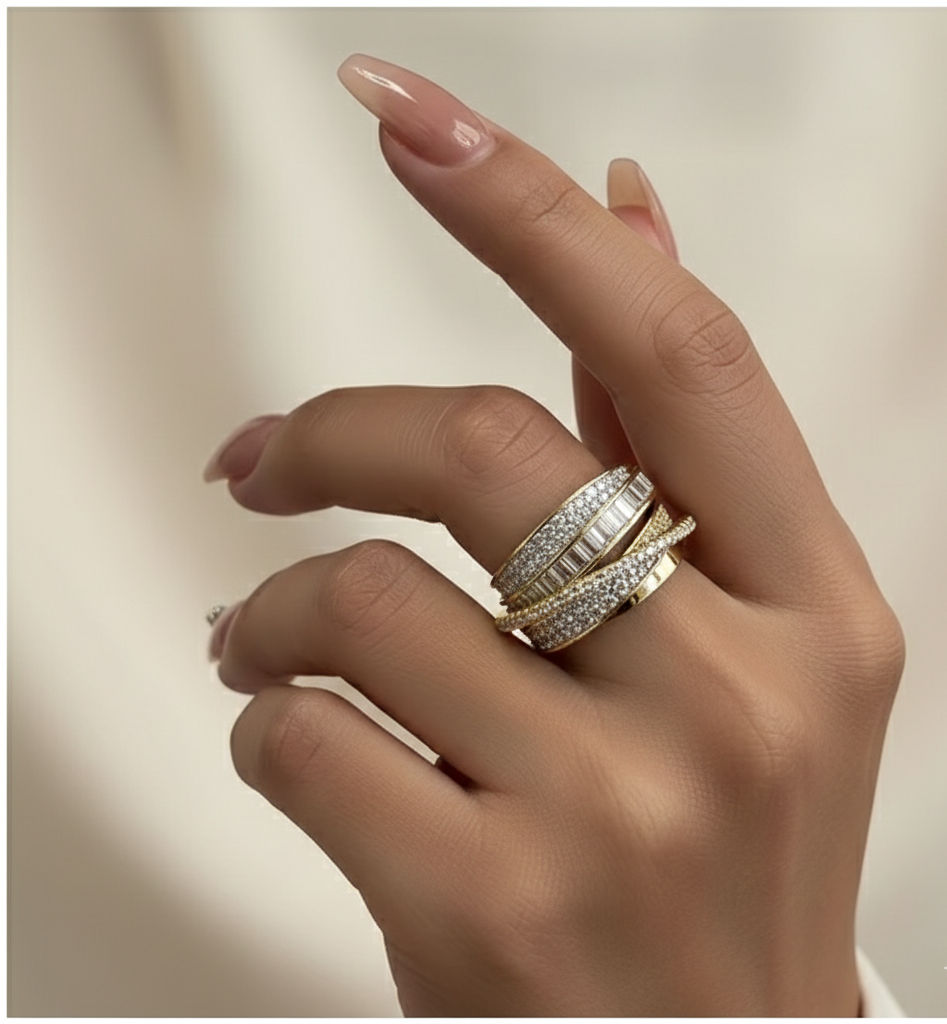 Hand wearing multiple rings with a soft beige background