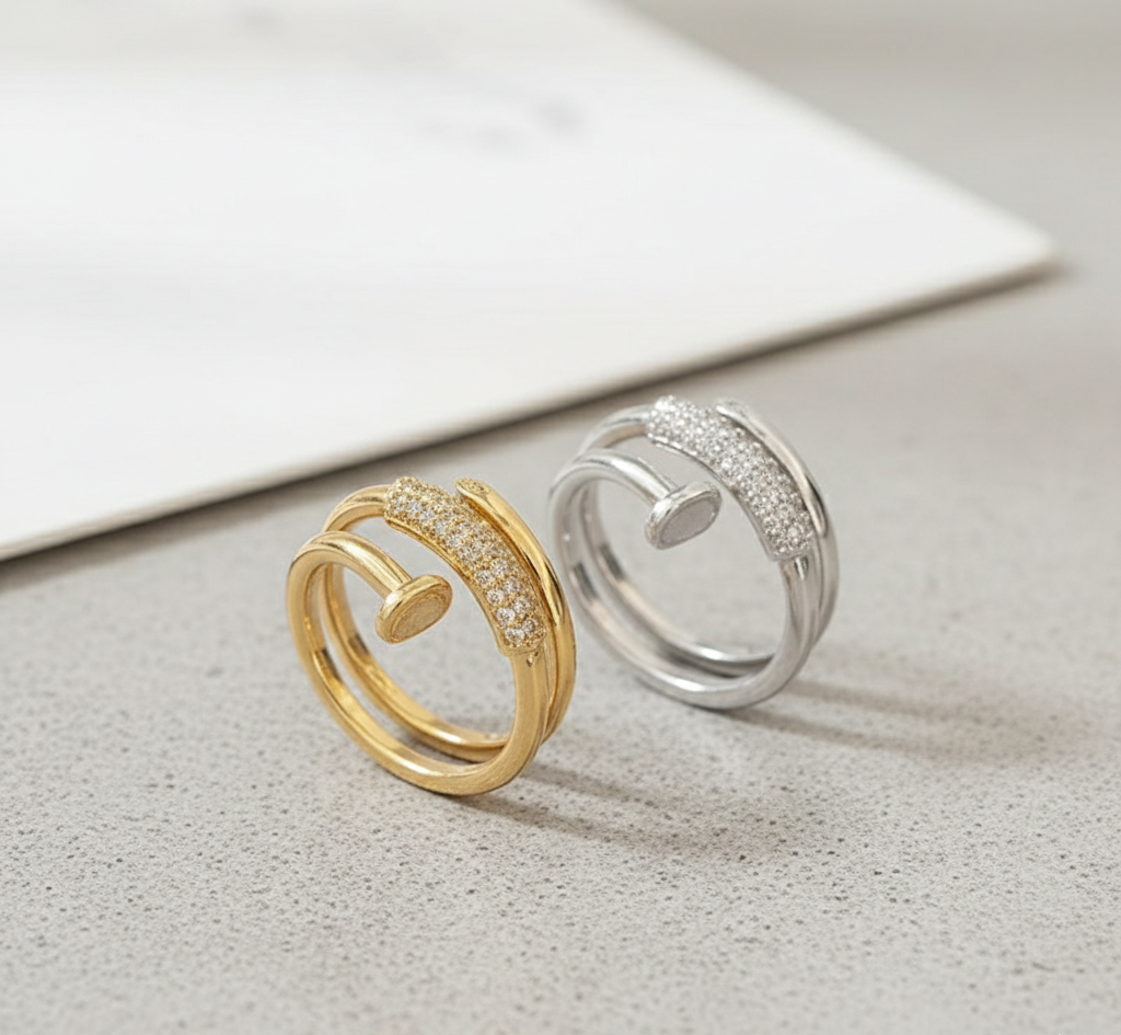 Gold and silver rings with diamond accents on a light surface